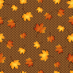 Seamless pattern. Autumn maple leaves on the knitted background