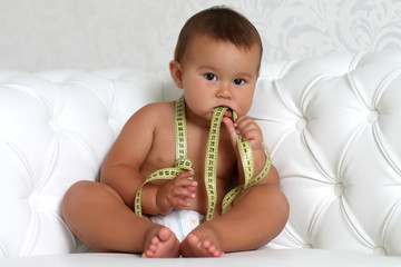 Adorable Baby Boy with a measuring tape