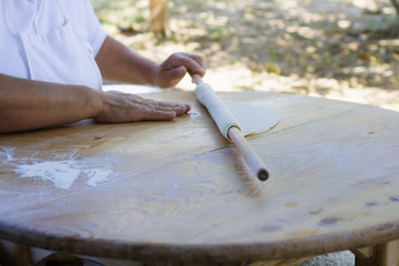 Chef rolls dough for tortillas