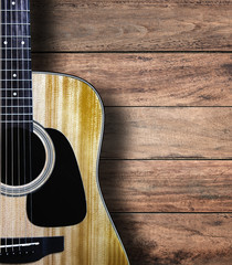 Obraz premium Guitar on wood background.