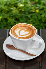 Cup of latte coffee on wooden