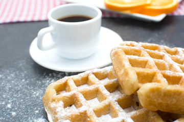 Waffles,oranges and coffee on the kitchen table
