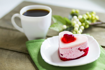 cream cake in the form of hearts and black coffee