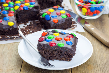 Homemade brownies with chocolate ganache and colorful candies
