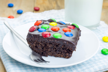 Homemade brownies with chocolate ganache and colorful candies