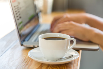 Coffee cup  with laptop on old wooden table