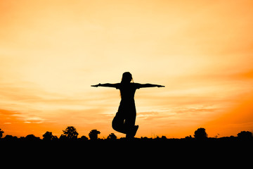 silhouette of woman at sunset , woman play yoga