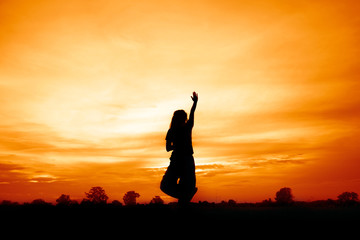 silhouette of woman at sunset , woman play yoga