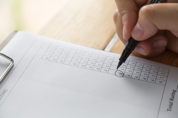 Hand with pen over application form