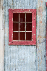 old rustic door with a red window