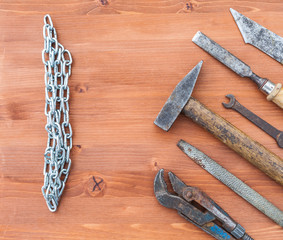 old rusty construction instruments on the wooden background