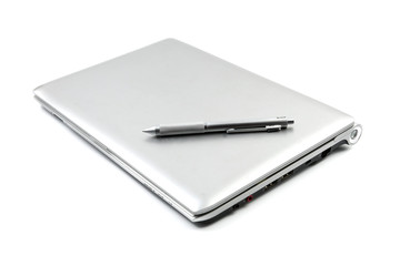 computer laptop and silver pen on white background