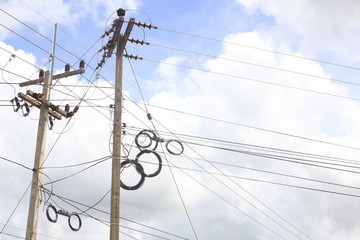 Energy and technology: electrical post by the road with power line cables
, transformers and phone...