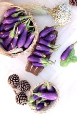 Obraz na płótnie Canvas Purple eggplants fresh for cooking on wood background.