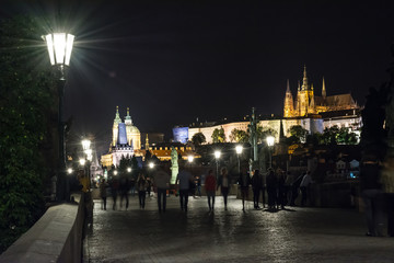 The Charles Bridge in the evening, in the light of lanterns. Medieval bridge over the Vltava River, which connects historic districts Lesser and Stare Mesto.