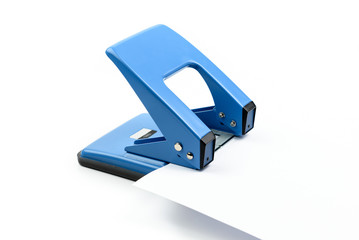 Blue office paper hole puncher on white background