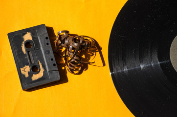 cassette and vinyl record on a colored background orange retro
