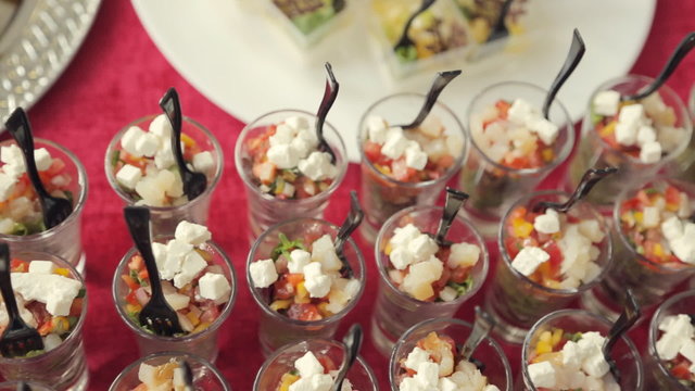 Appetizing vegetable salad in individual containers on the table