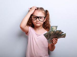 Small professor in eye glasses scratching head, holding money an
