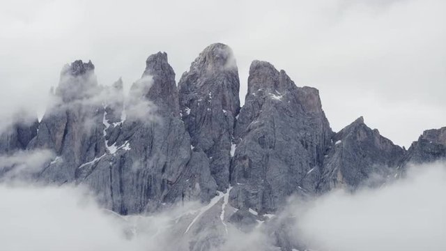 Close up shot of clouds passing over mountaintops / Dolomites, Italy