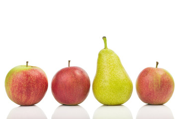 One pear in the middle of apples isolated on white