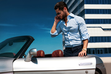 Handsome man near the car. Luxury life.