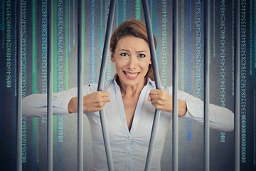 Stressed woman bending bars of her digital prison binary code cell