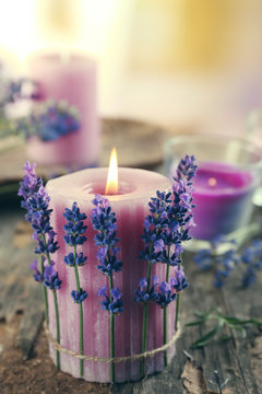 Fototapeta Candles with lavender flowers on table close up