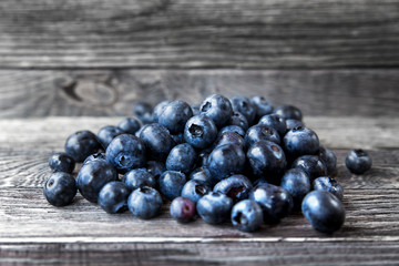 Blueberry lie on wooden background. Rustic cozy background with healthy food. Fresh-gathered berries full of vitamins, good for diet nutrition and healthy meals.