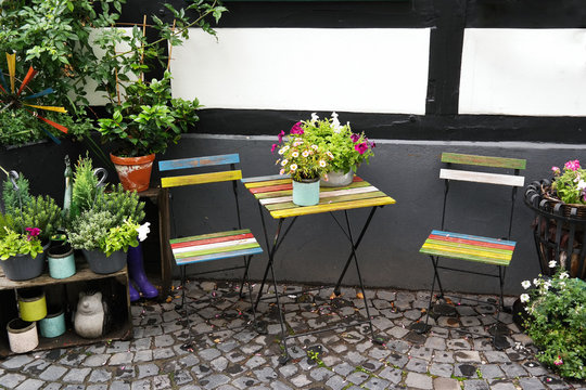 Colorful bistro furniture in a tee garden in Germany