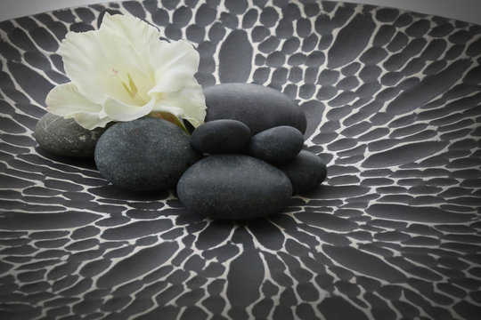 Fototapeta Spa stones with flower on gray background