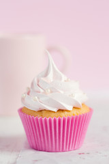Romantic pink cupcake on pastel background