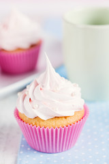 Romantic pink cupcake on pastel background