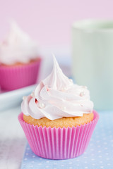 Romantic pink cupcake on pastel background