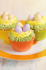 Easter cupcakes decorated with eggs in nest