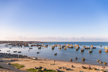 Naklejka premium Colorful traditional fishing boats near Mui Ne, Binh Thuan, Vietnam. Early morning, fishermen float to the coast with a catch.