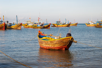 Colorful traditional fishing boats near Mui Ne, Binh Thuan, Vietnam. Early morning, fishermen float to the coast with a catch.