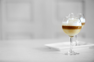 Wine glass with jelly on light background