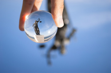 Justice sculpture photo from a glass ball.