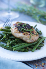Sauteed pork chop with rosemary over spicy green beans