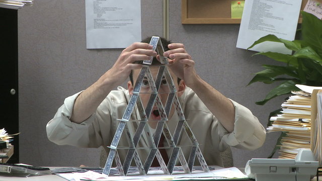 man building house of cards