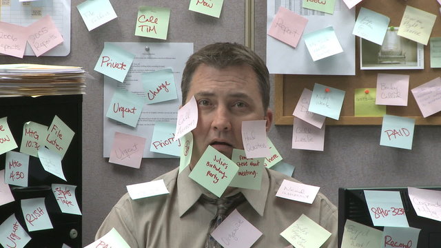 man at work covered with sticky notes 