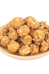 Almond and caramal popcorn on white background