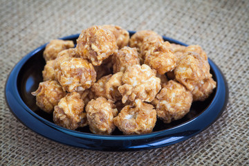 Almond and caramal popcorn on tablecloth background