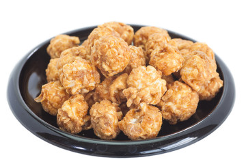 Almond and caramal popcorn on white background