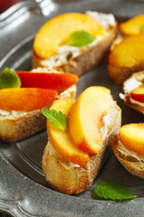 Crostini with cream cheese and fresh peaches.