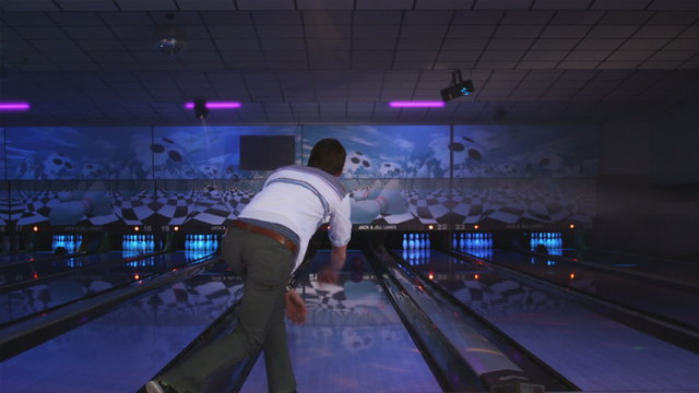 young man bowling at a bowling alley