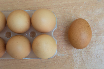 Chicken egg on wood and six chicken eggs in panel eggs on wood b