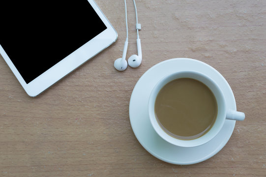 Coffee with taplet and headphones