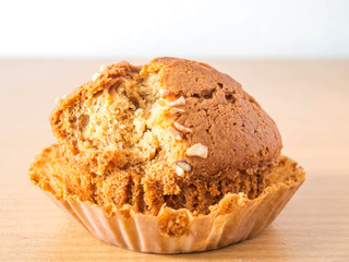 Peanuts on top of Banana cake on a brown and white Background.